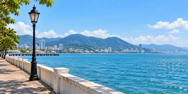 Illustrative Penang-style waterfront promenade, blue sea and distant hills.